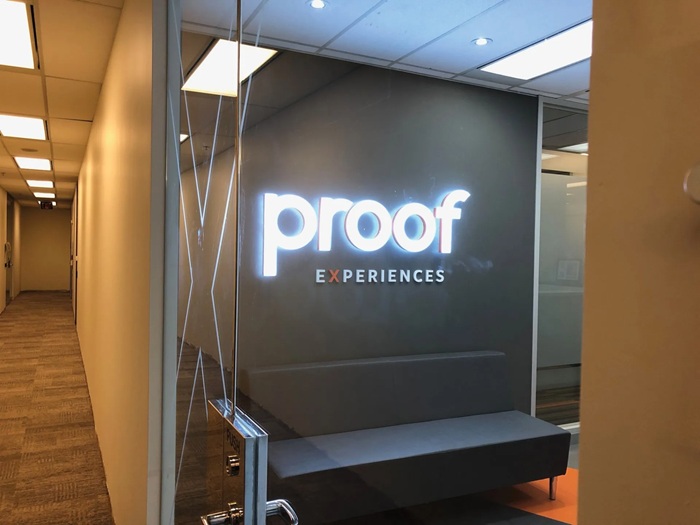 Frontlit LED acrylic letter sign for office reception wall, illuminated company logo wall sign indoor.
