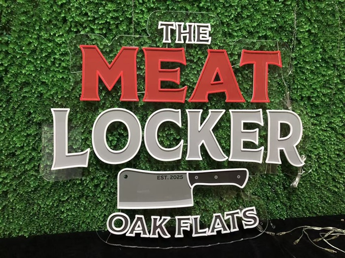 Custom butcher shop split neon sign with cleaver graphic.