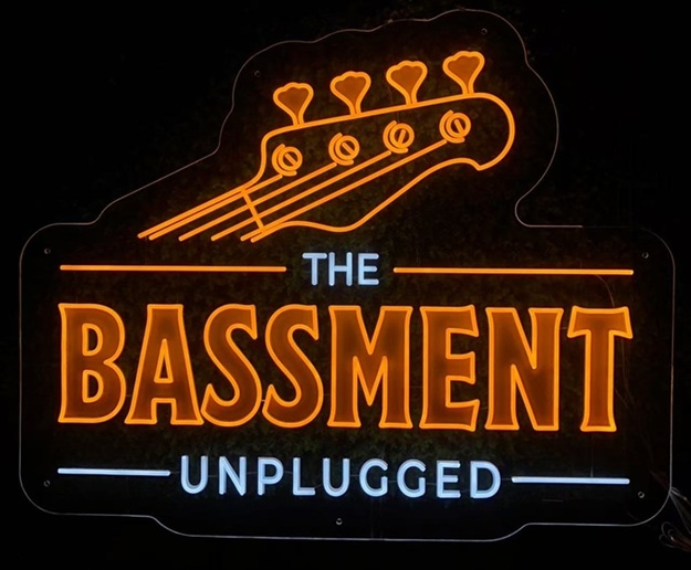 Music shop custom split neon sign with bass headstock graphic.