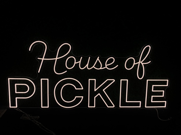 Cursive font custom store split neon letter sign.