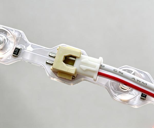 LED strip solder-free terminal wire connector close-up, waterproof lens module cable plug.