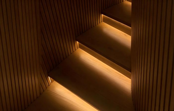 Side view SMD LED strip recessed under wooden stair tread.